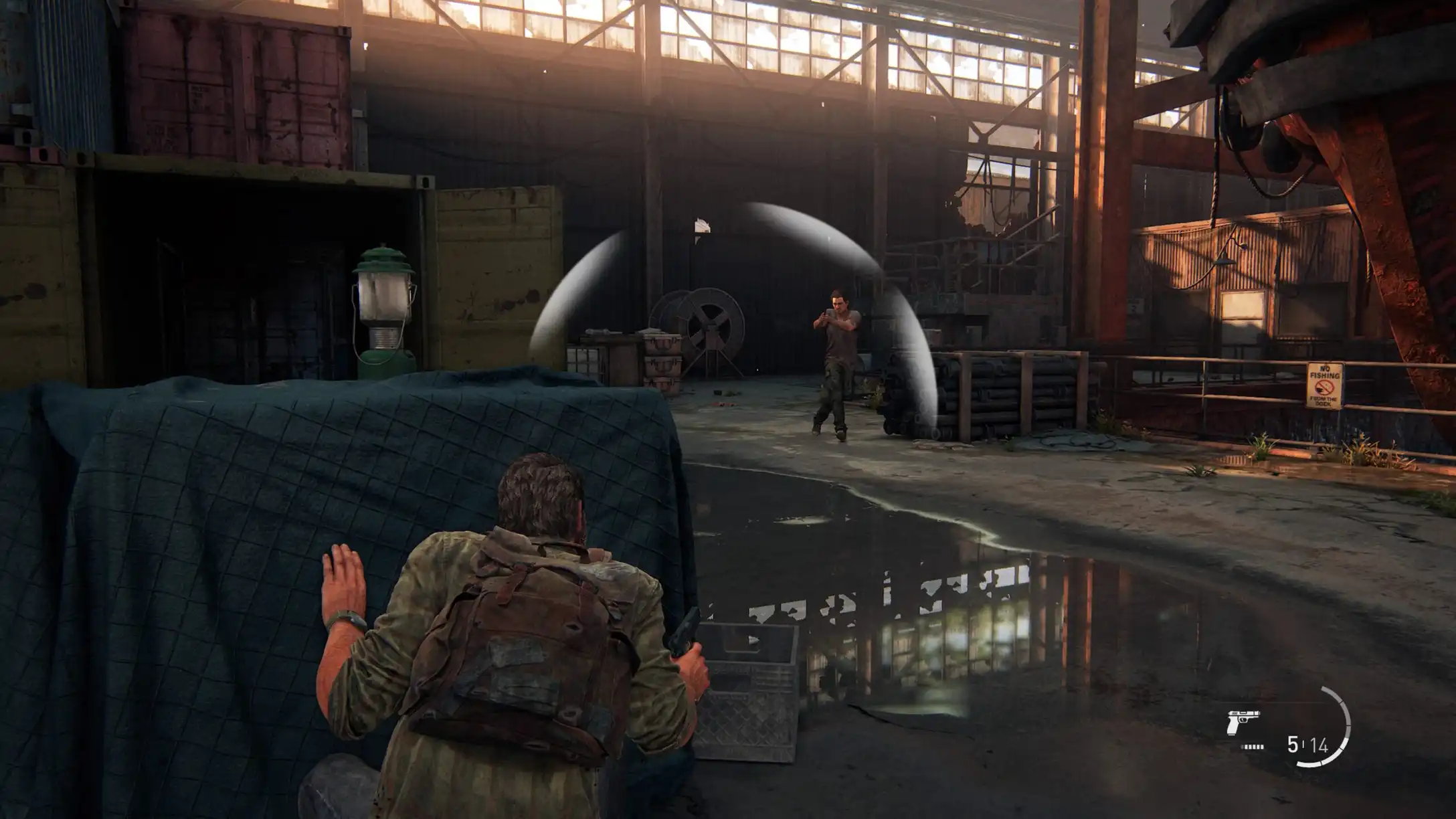 The Last of Us Part I: Joel crouched behind cover with visible threat indicator UI elements.